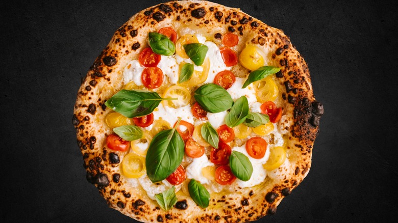 Pizza topped with tomatoes, basil