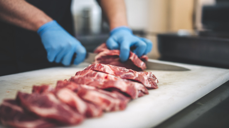 a butcher processing meat