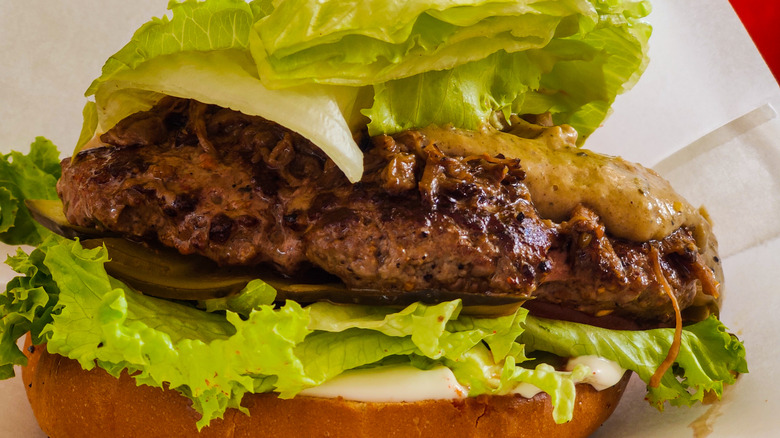 beef burger patty with iceberg lettuce