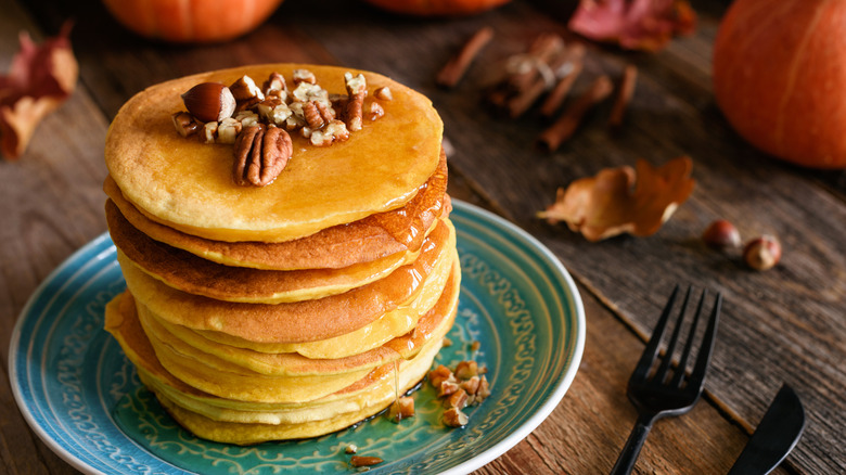 Stack of pumpkin pancakes with apple syrup.