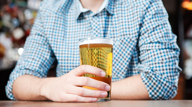 Man holding beer glass