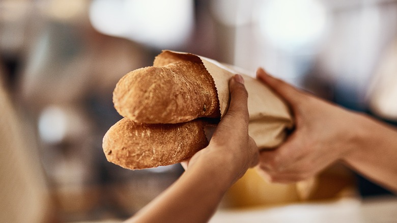 Customer taking two baguettes