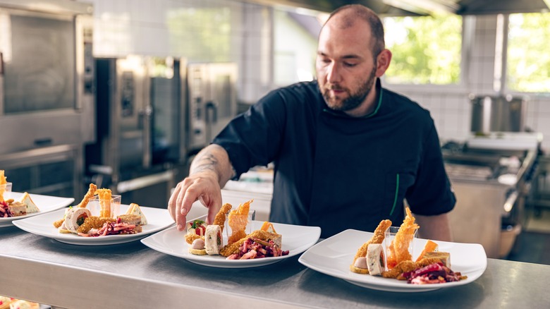 chef plating food at a restaurant