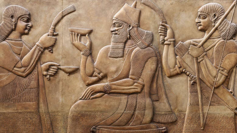 Artwork of fanned Assyrian king holding bowl