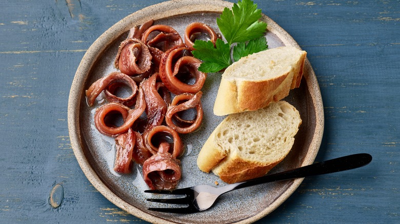 Anchovies on plate with bread