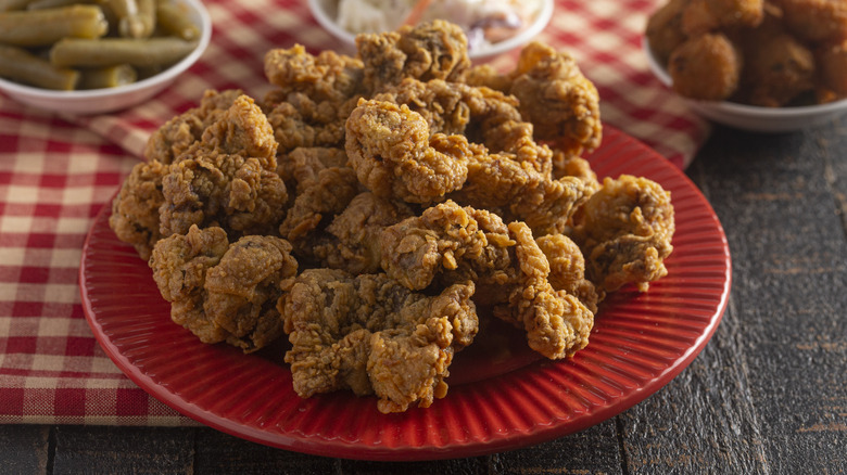 Fried chicken gizzards on red plate