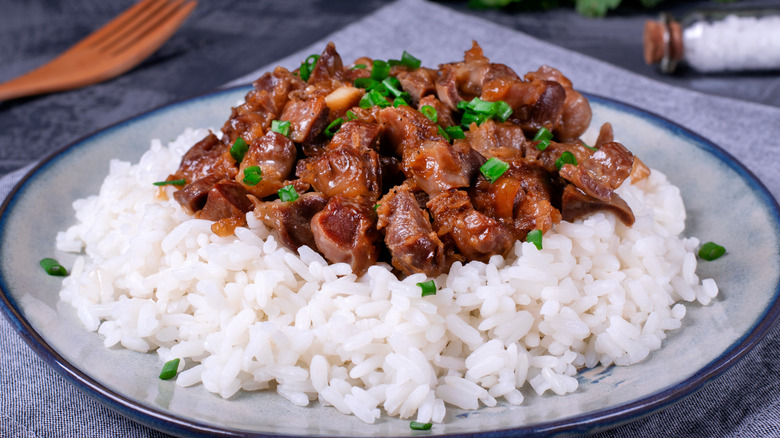 Saucy chicken gizzards over rice