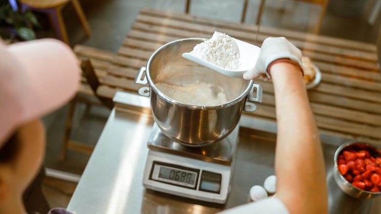 Weighing flour on kitchen scale