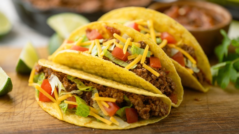 hard shell beef tacos on a board