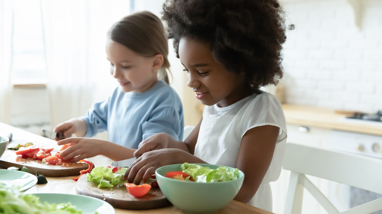 Children preparing salad