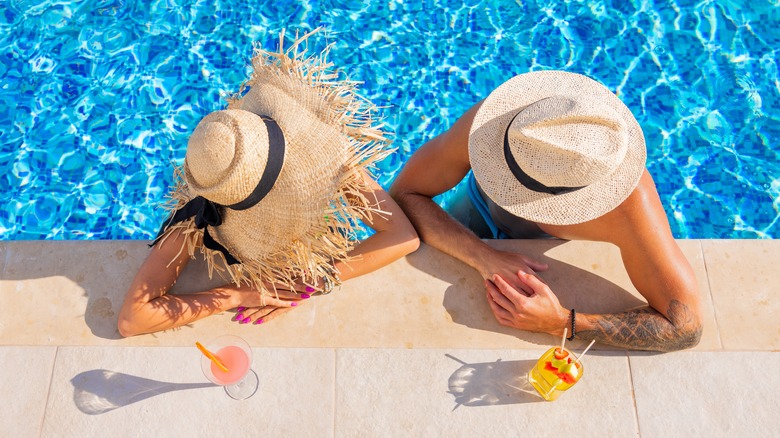 couple in pool with drinks