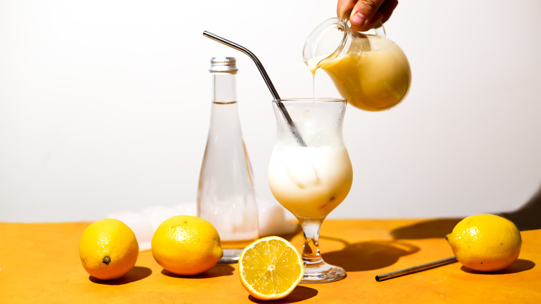 pouring creamy lemonade into glass