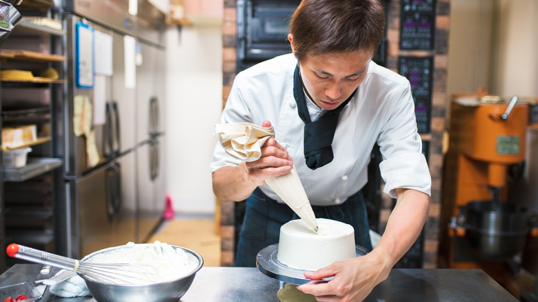 man frosting a cake