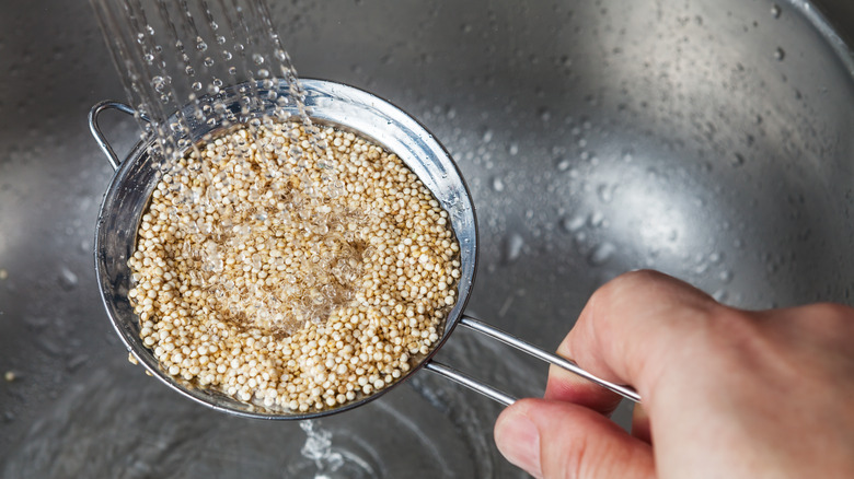 rinsing quinoa over the sink