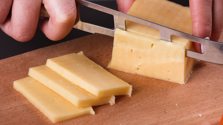 Cutting cheese with a channeled cheese knife