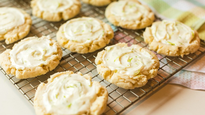 Frosted cookies with lime zest on rack