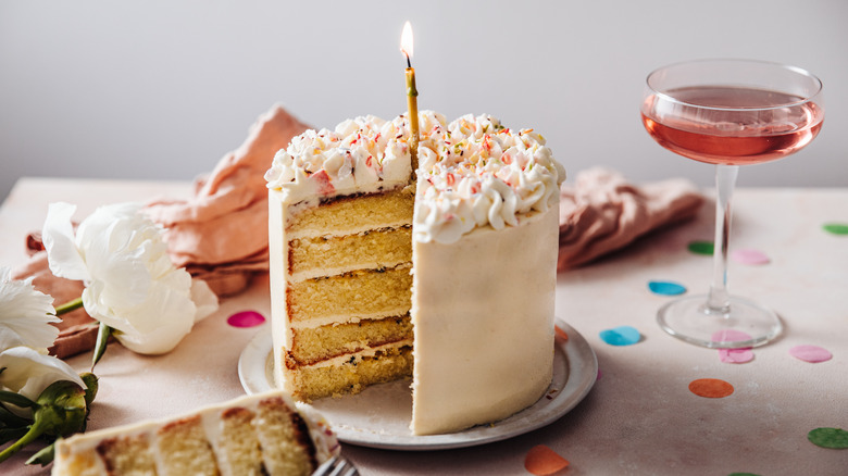 frosted birthday cake with candle