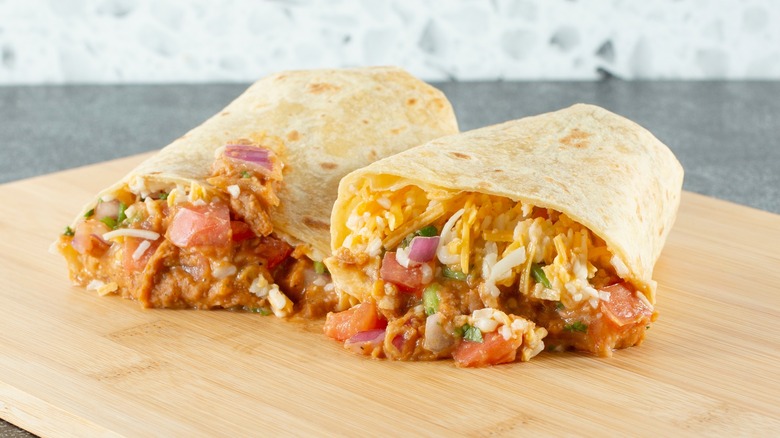 burrito on cutting board cut in half