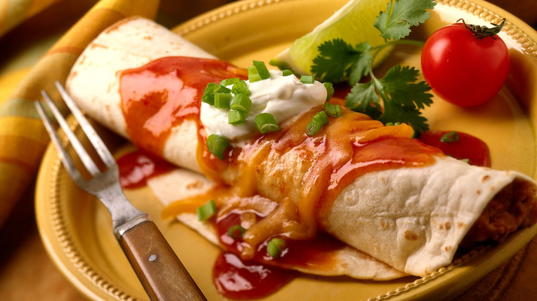 Burrito covered in sauce, cheese