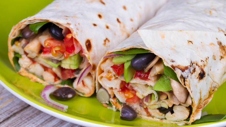 frozen burrito cut in half on green plate