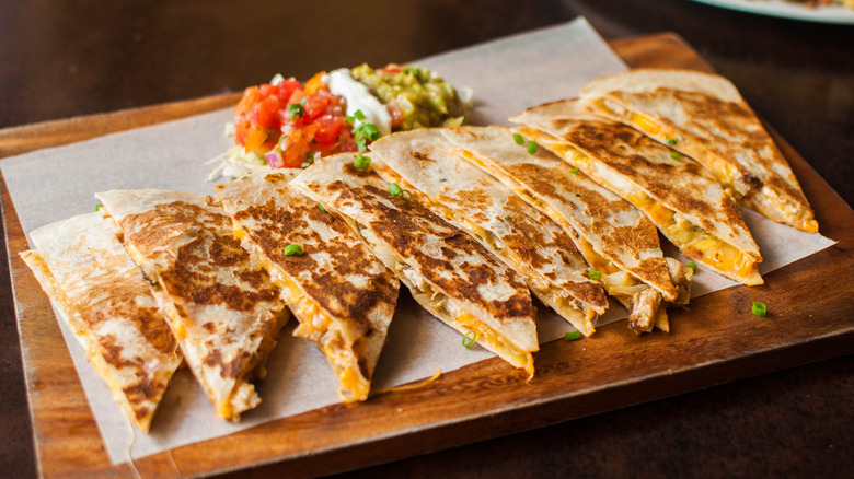 Quesadillas sections laid out on parchment