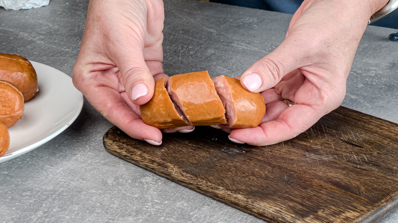 Person holding a spiral-cut sausage.