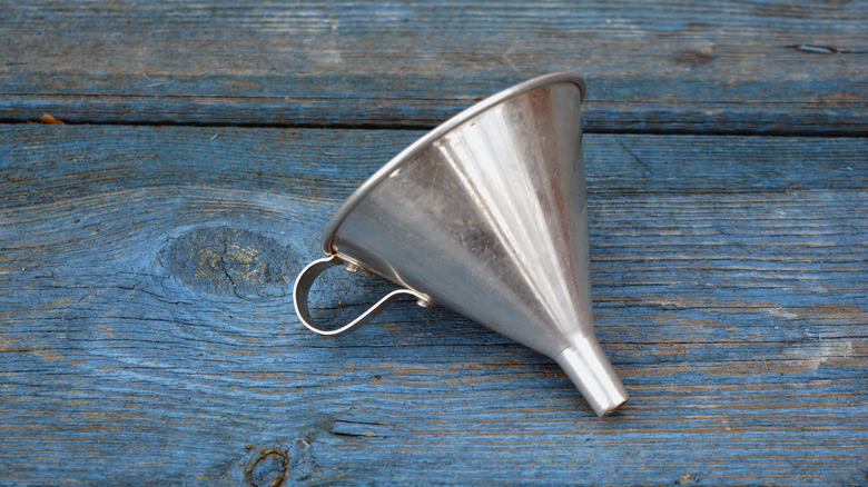 Funnel on wooden background