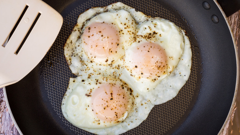 three eggs in a frying pan 