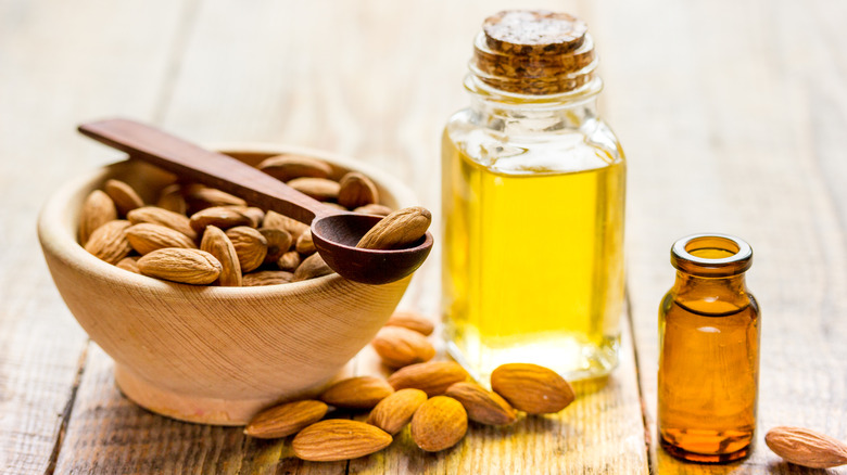 Almond extract next to bowl of almonds
