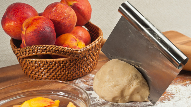 Pie dough with bench scraper