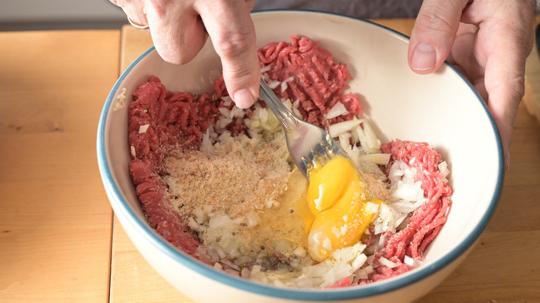 mixing meatballs ingredients in bowl