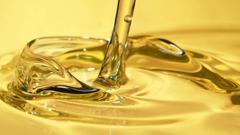 Closeup shot of pouring olive oil