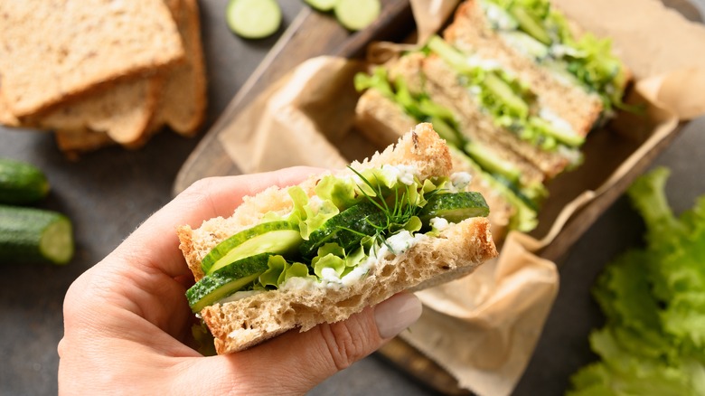 Cucumber sandwich in hand