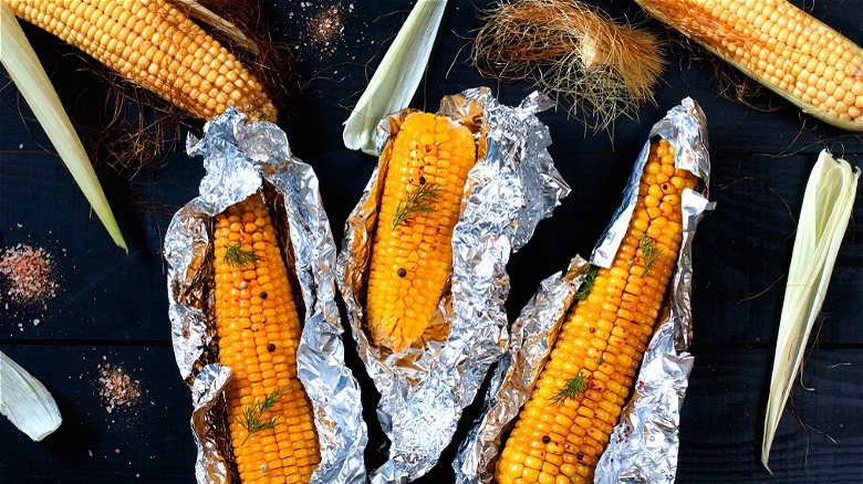 Seasoned corn cobs wrapped in foil 