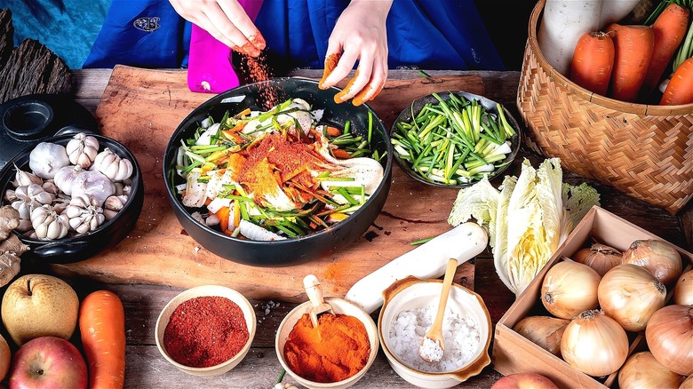 Hands mixing homemade kimchi 