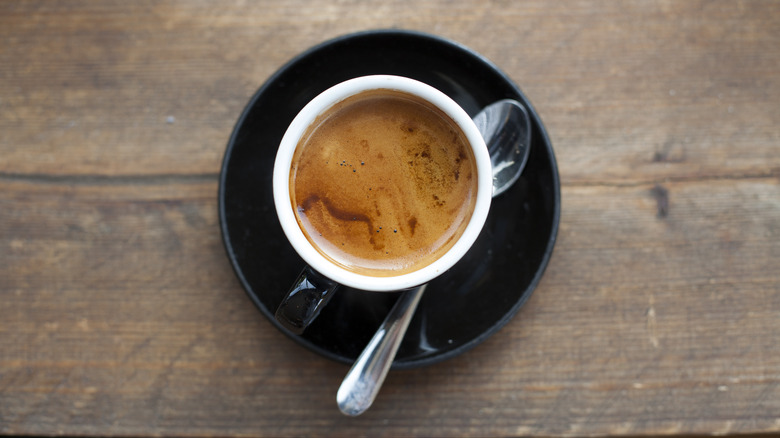 Cup of espresso on a saucer with spoon