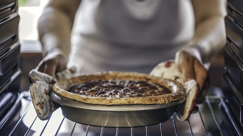 taking a pie out of the oven