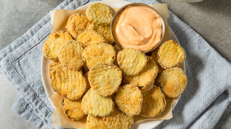 plate of fried pickles with dipping sauce