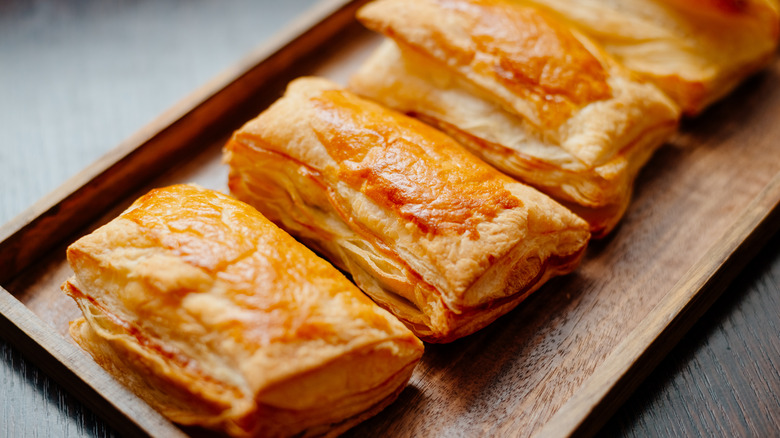 puff pastries on wooden tray