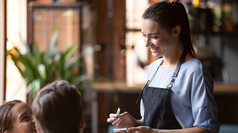 Person taking couple's order