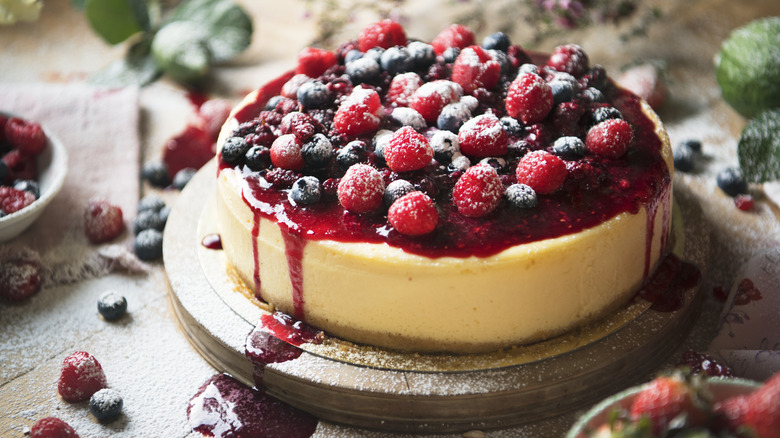 whole cheesecake topped with berry compote