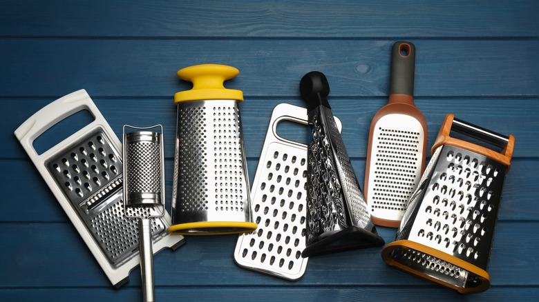 Types of graters on wood background