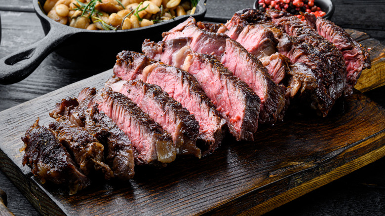 Sliced steak on cutting board