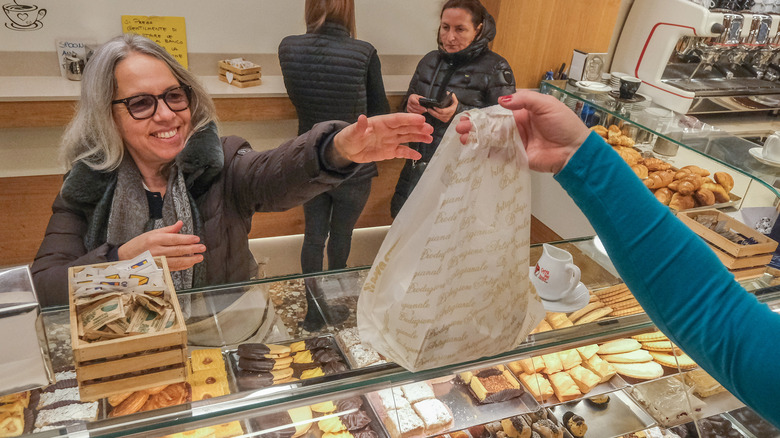 Woman buying products at bakery