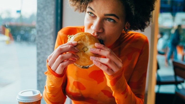 Woman eating bagel