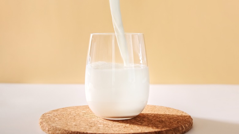 almond milk being poured into glass