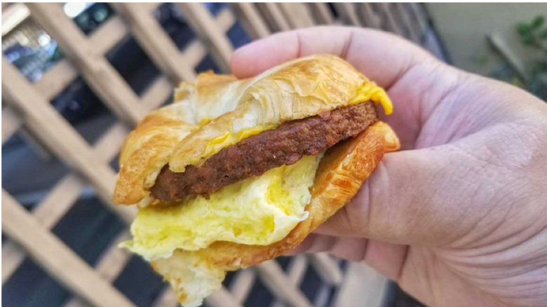 person holding Impossible Croissan'wich