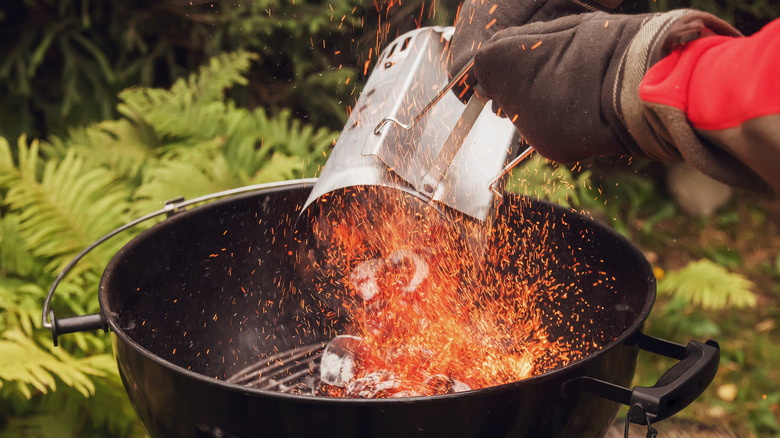 Charcoal dumped into a grill from a chimney starter