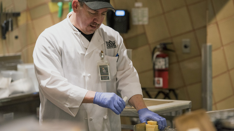 Whole Foods employee cuts cheese