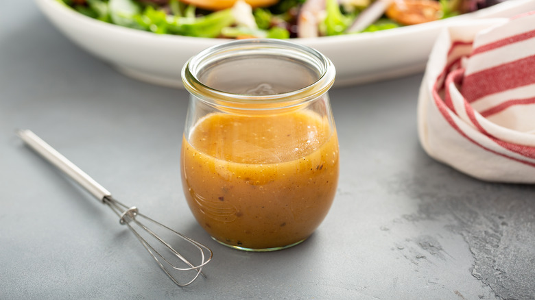 Vinaigrette in jar with small whisk